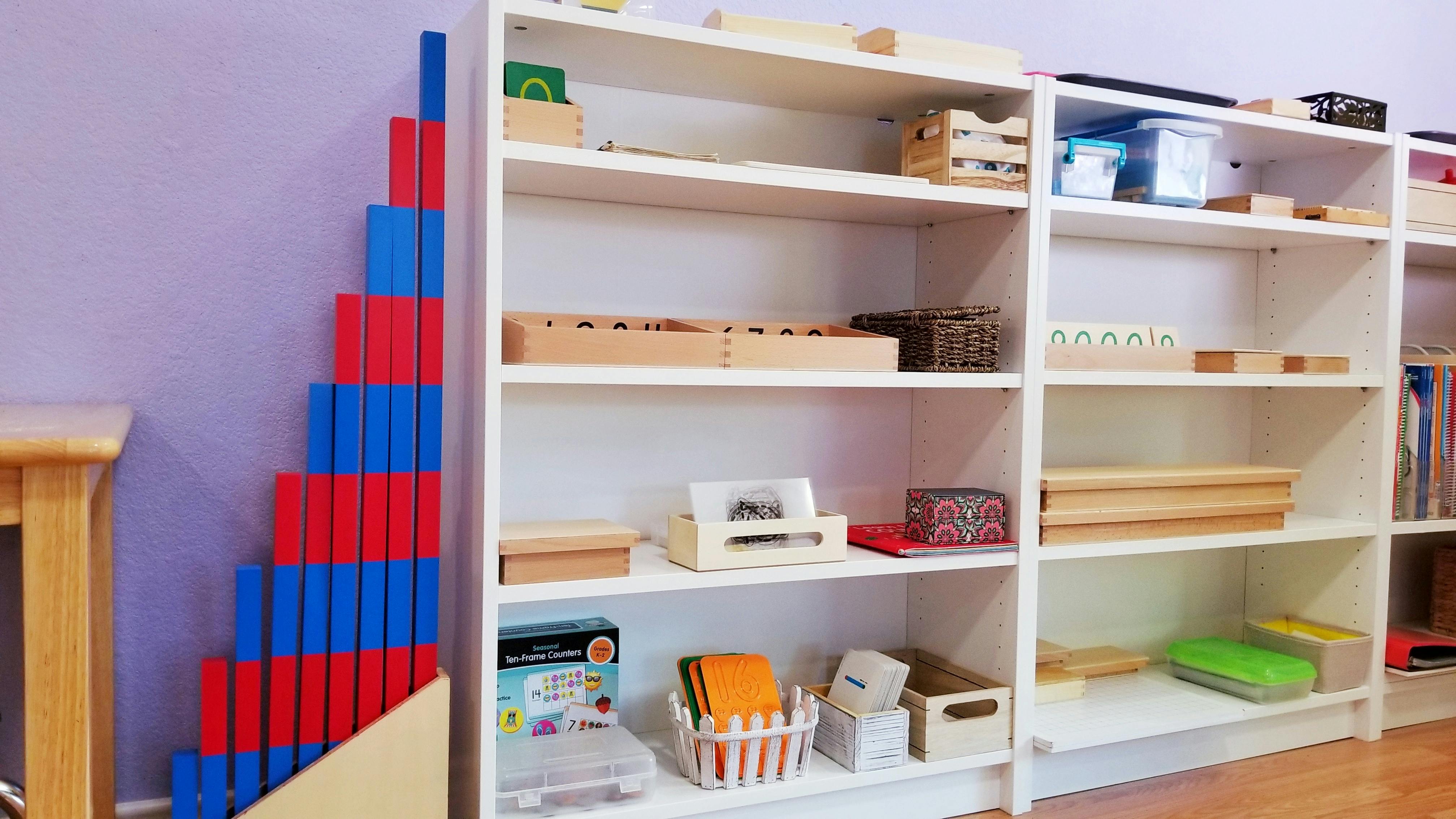 Red and blue blocks next to white shelves with various items