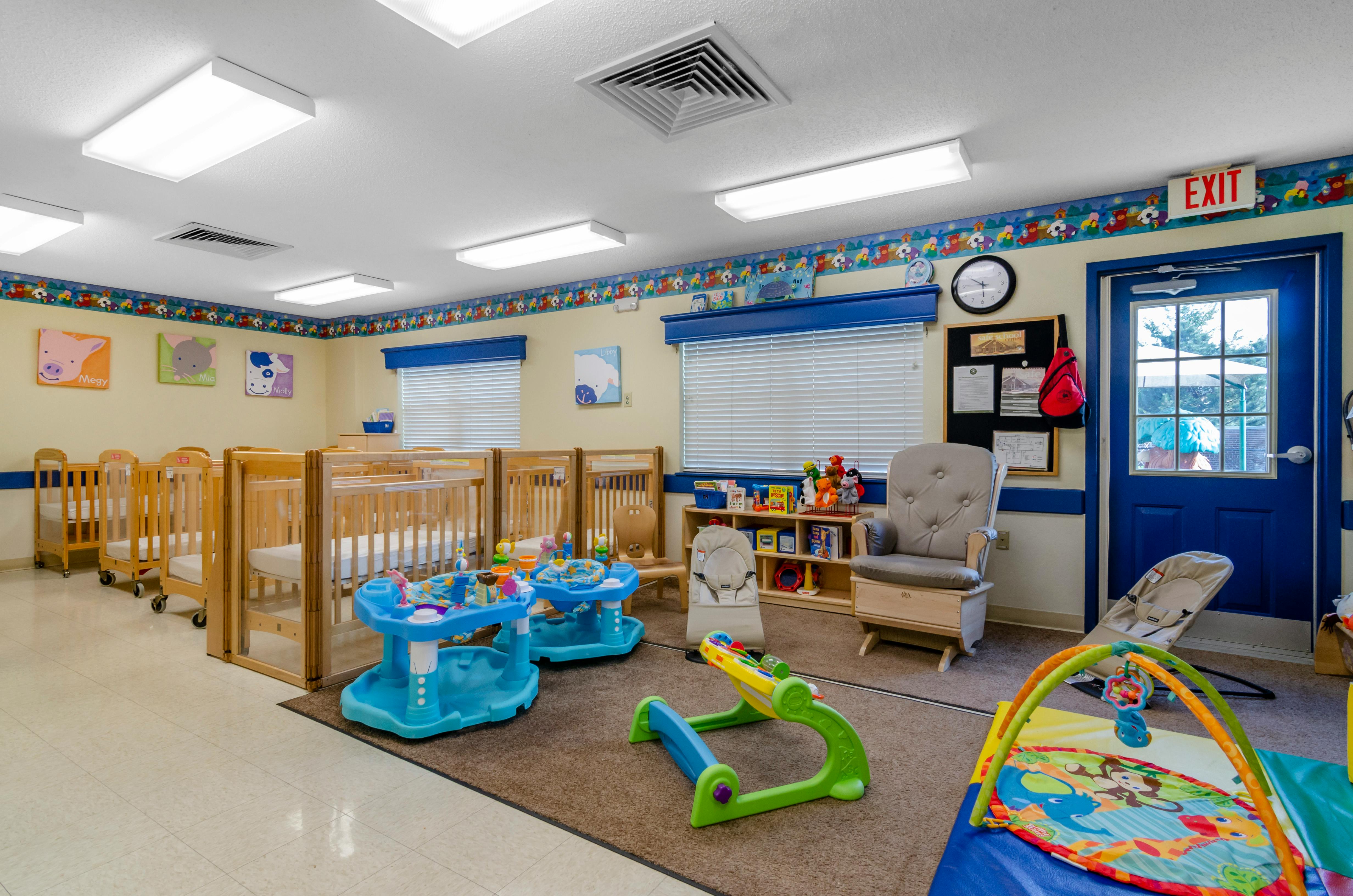 cribs and baby play equipment in a daycare
