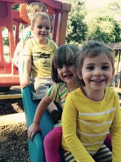 Four children on a slide