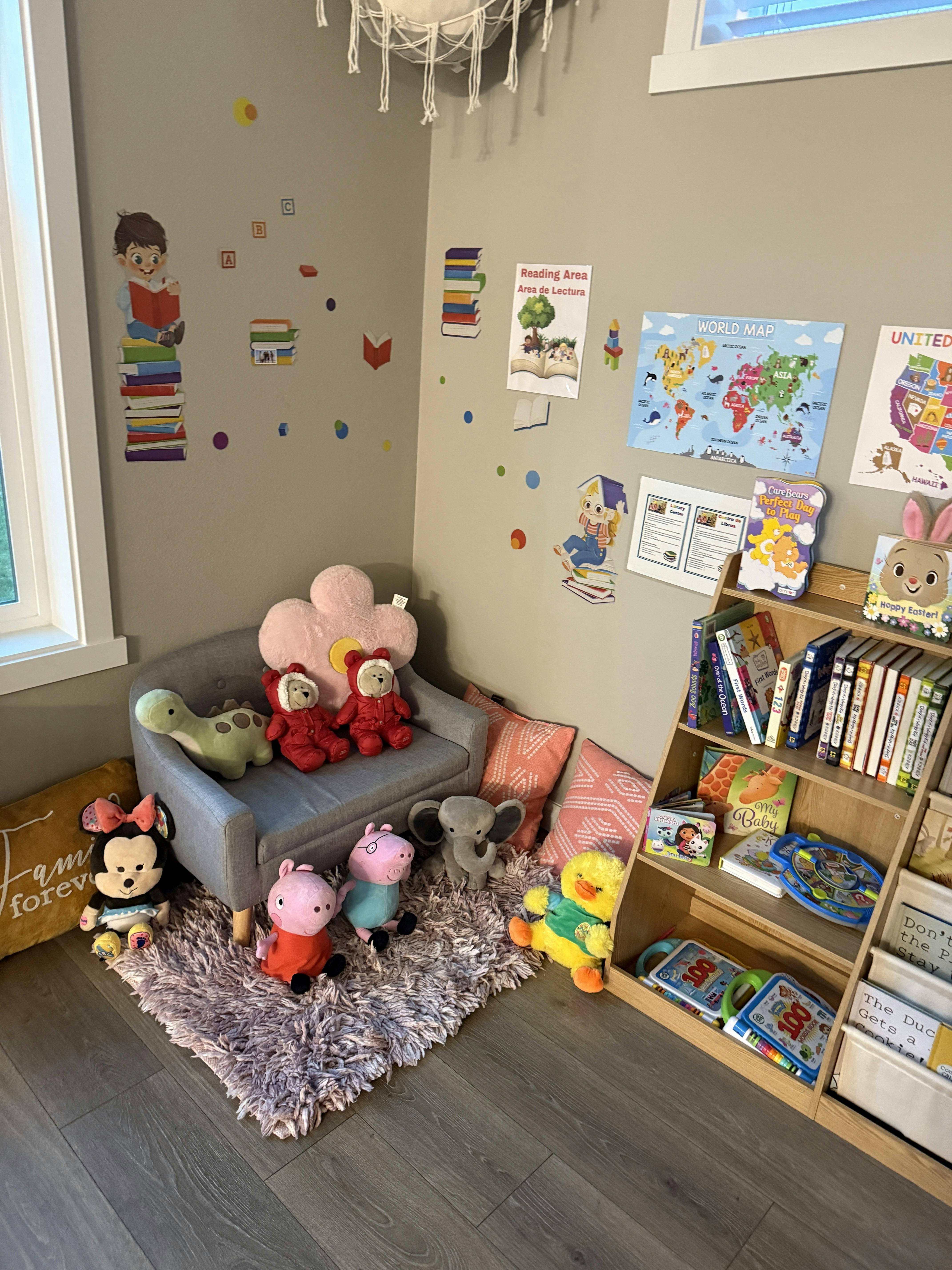 Children's reading nook with a small couch, stuffed animals, and a bookshelf