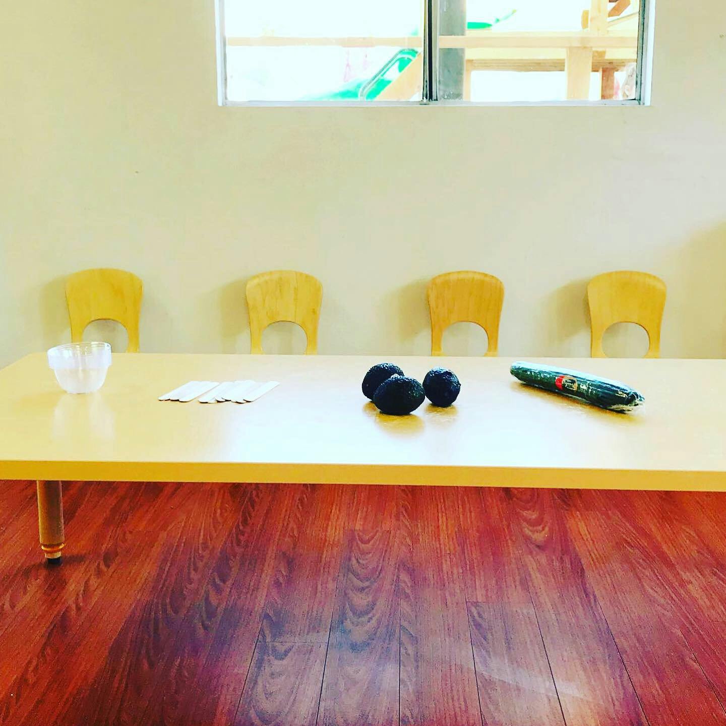 Table with chairs, blueberries, and a remote control