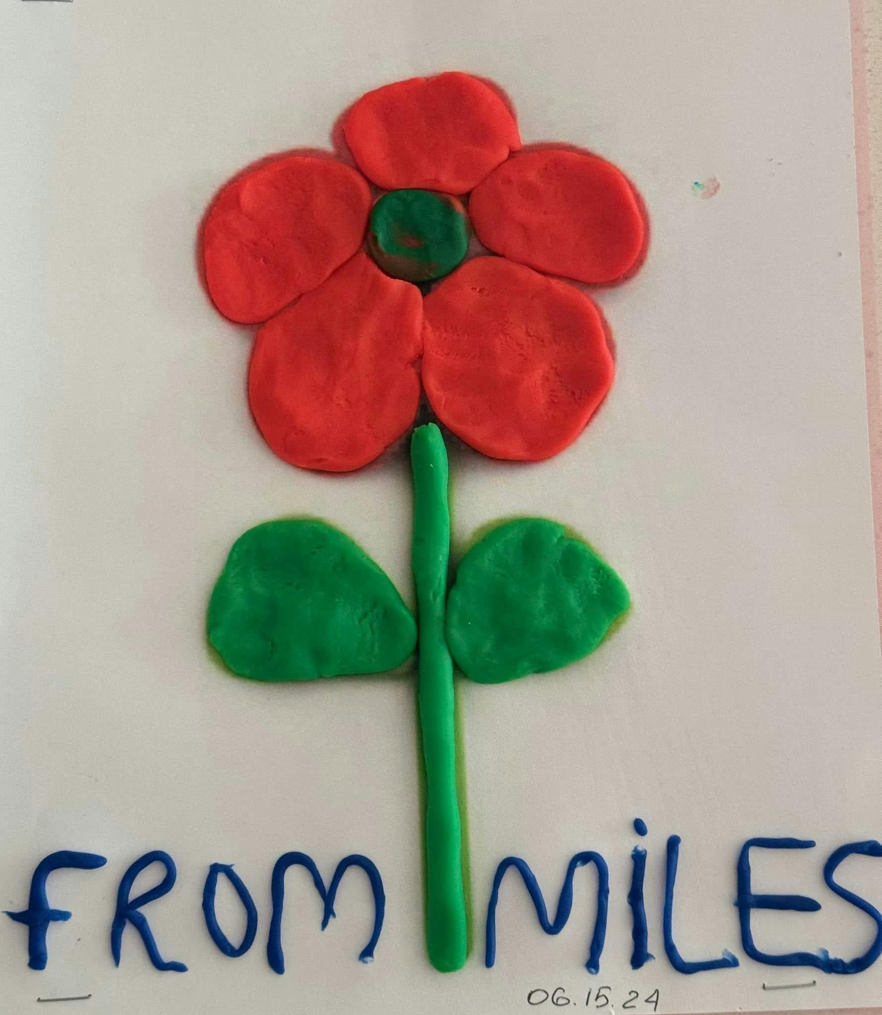 Play-Doh flower with red petals and green stem and leaves, text "FROM MILES"