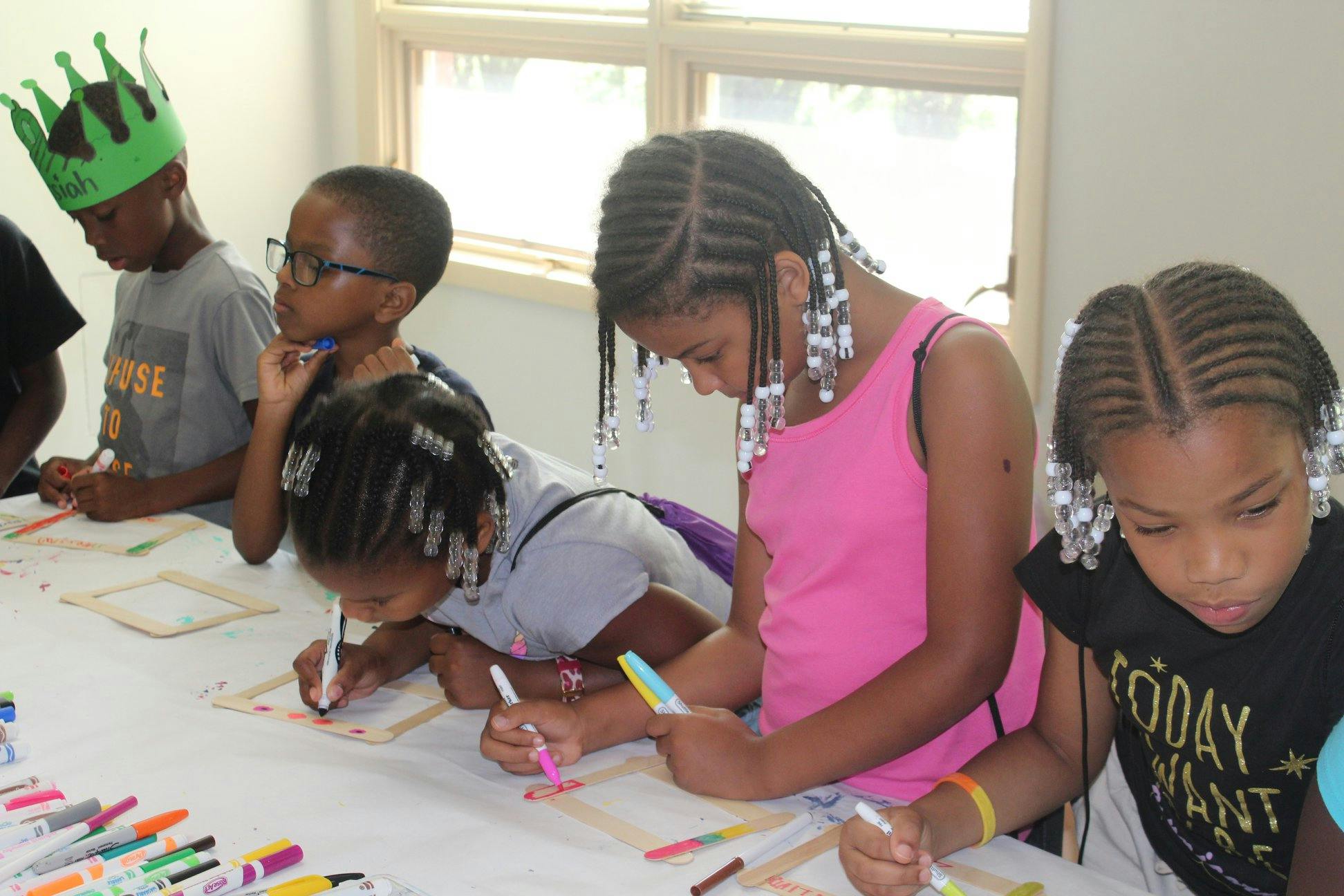 Children coloring at a table