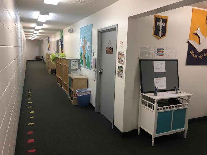 Hallway with a bulletin board and a door