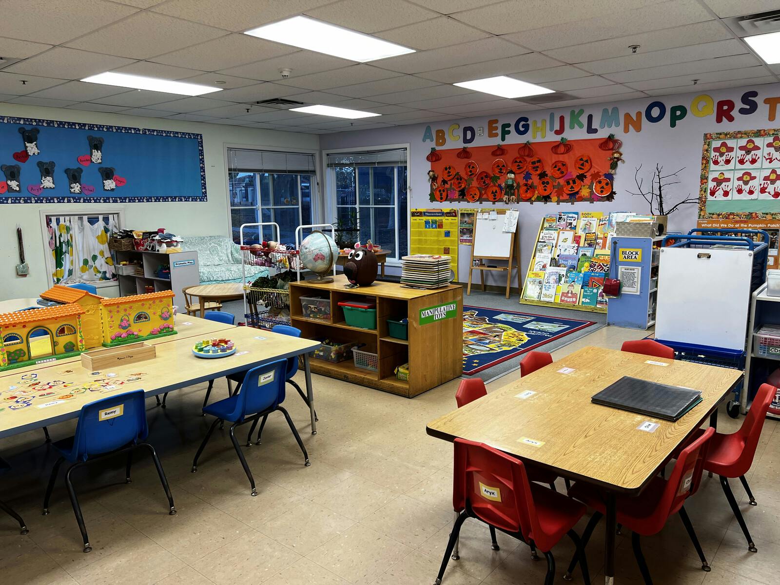 Empty classroom with small tables and chairs