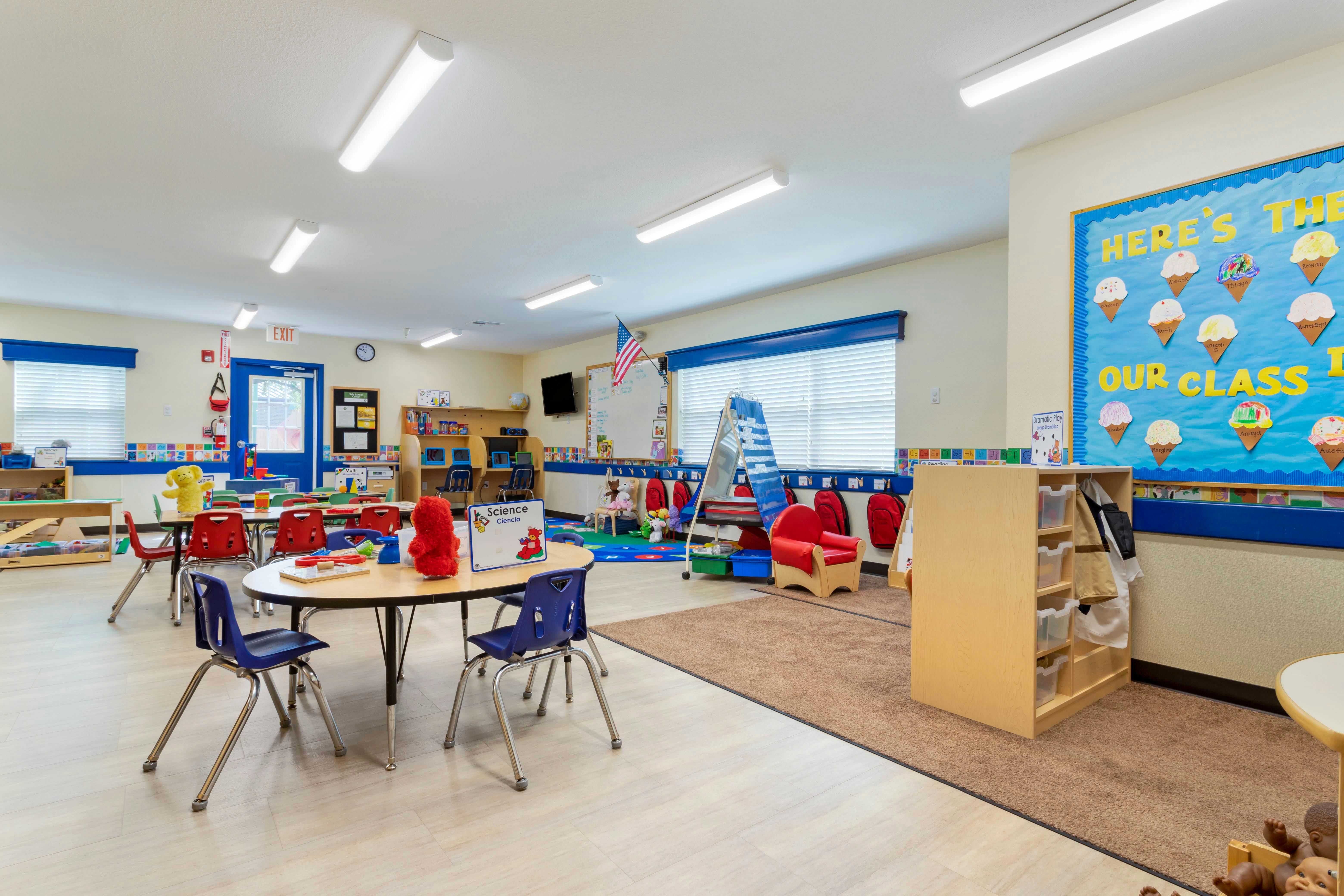 An empty early childhood classroom with colorful furniture and learning materials