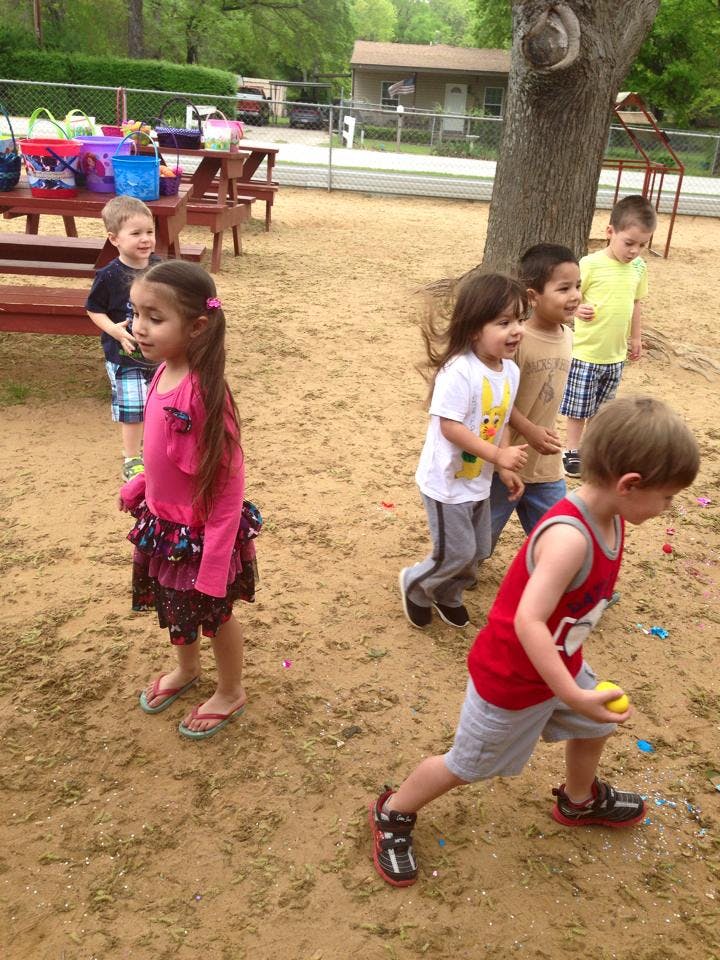 Children playing outdoors in a sandy area