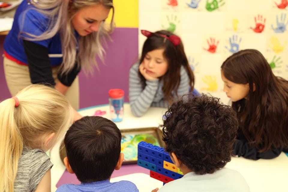 Adult and children looking at a tablet