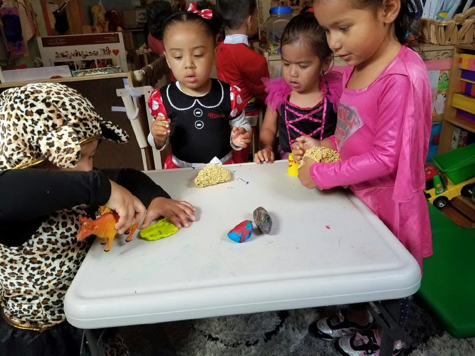 Children playing with toys at a table