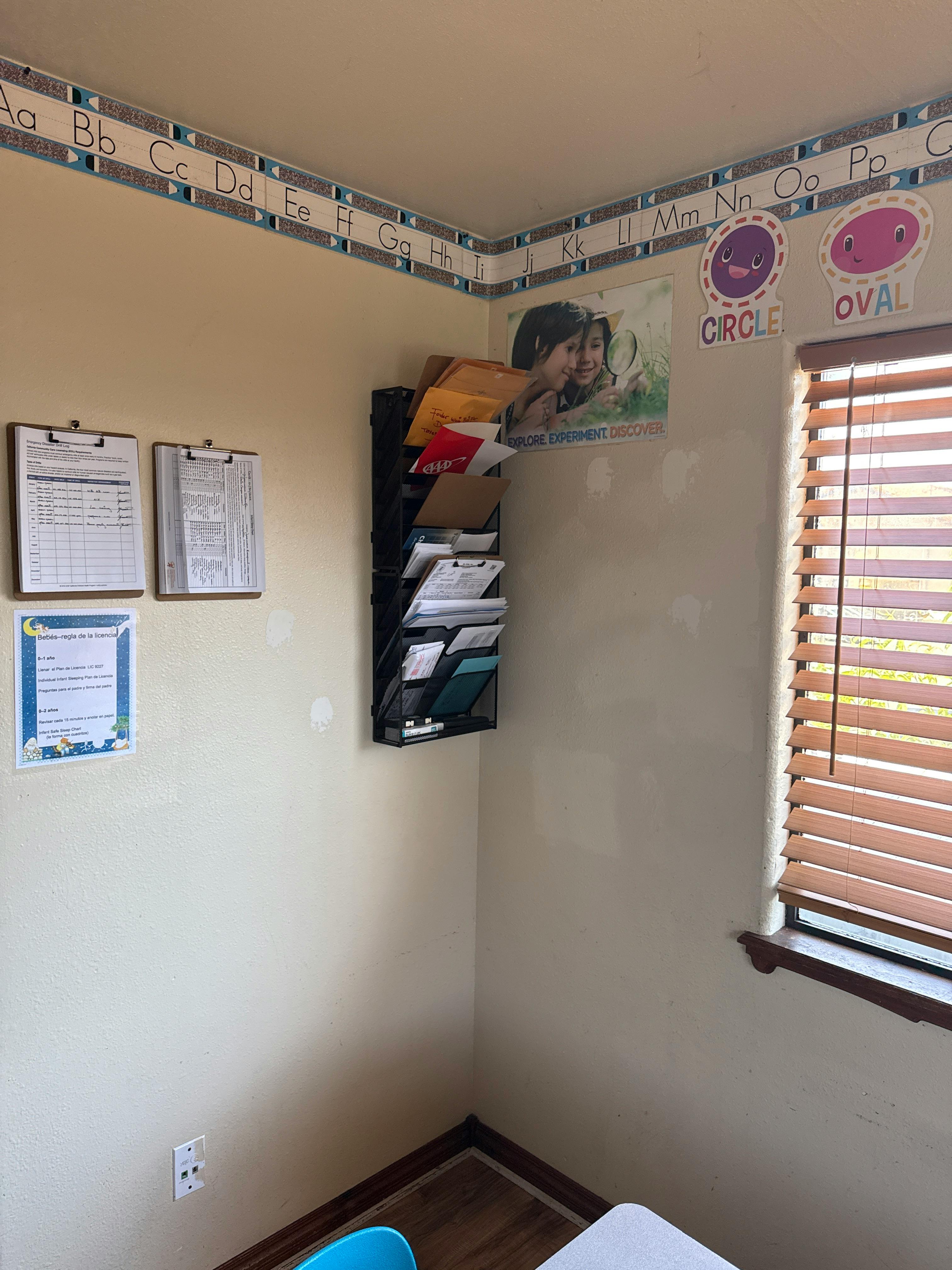 Classroom wall with alphabet border, shape cutouts, posters, and document holder