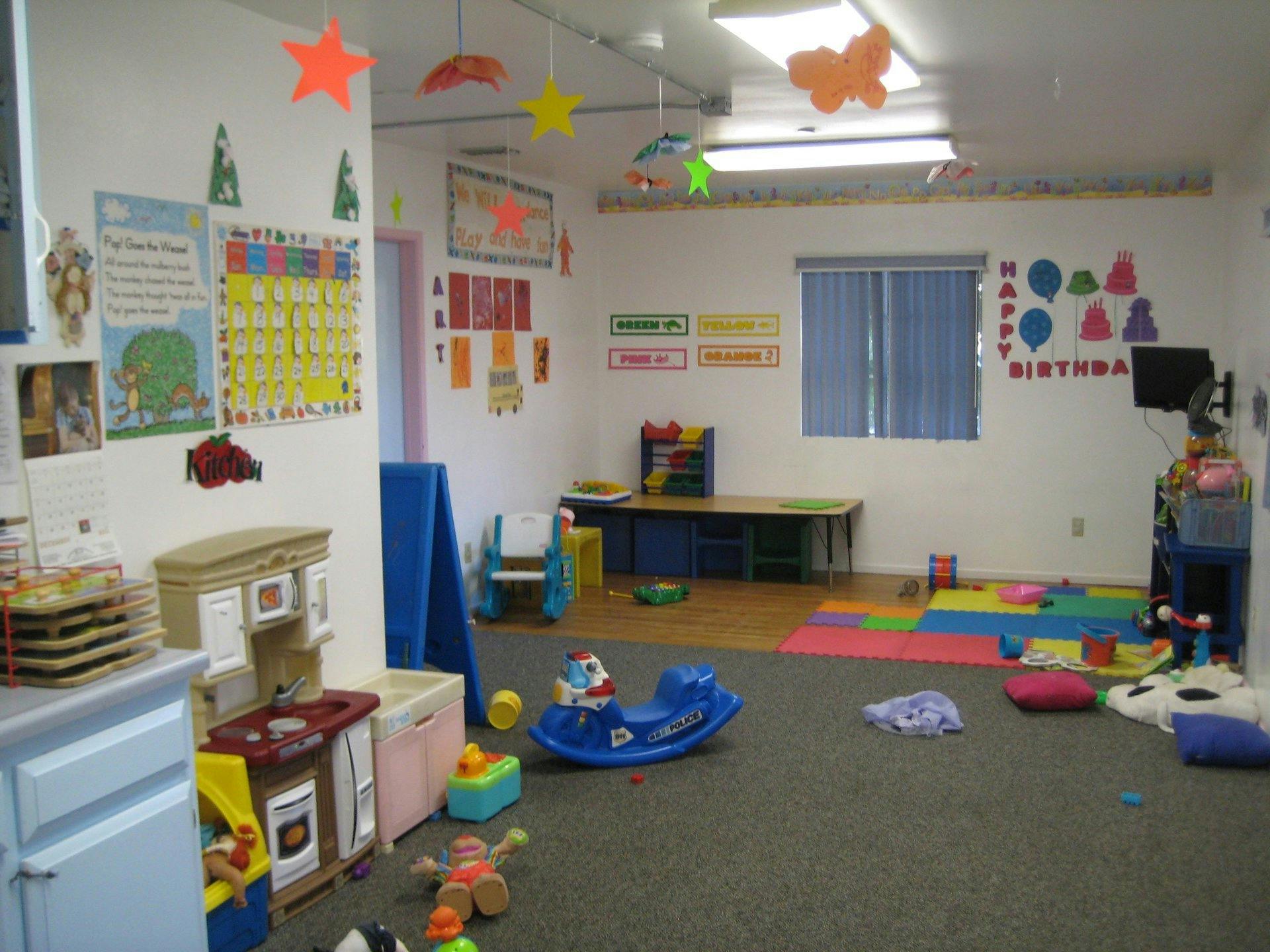 Playroom with toys, play kitchen, and colorful decorations