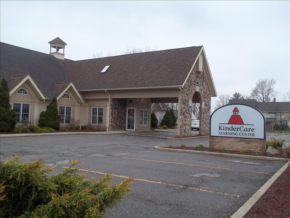 KinderCare Learning Center building with a drive-through entrance and sign