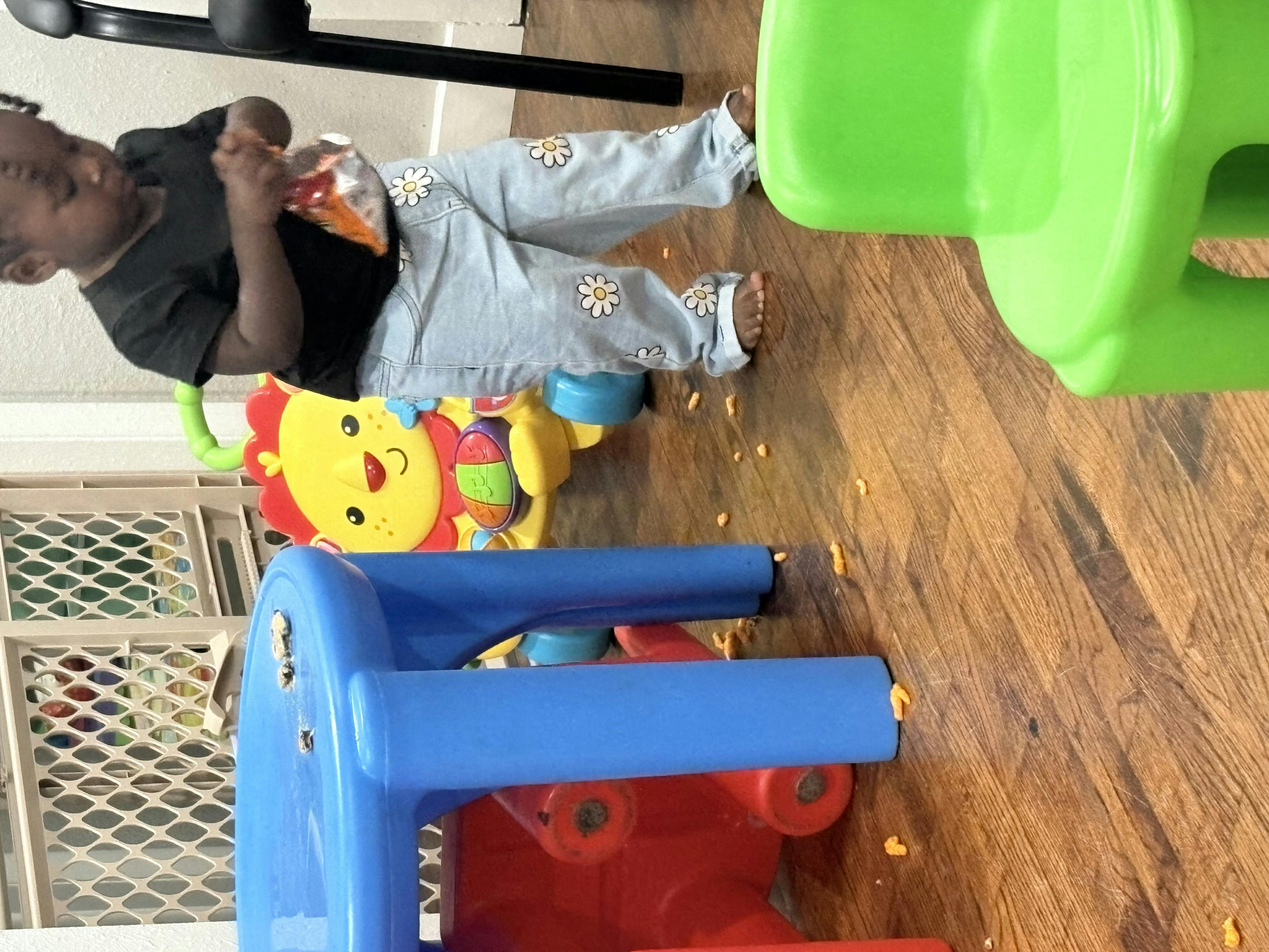 Child standing next to a colorful toy