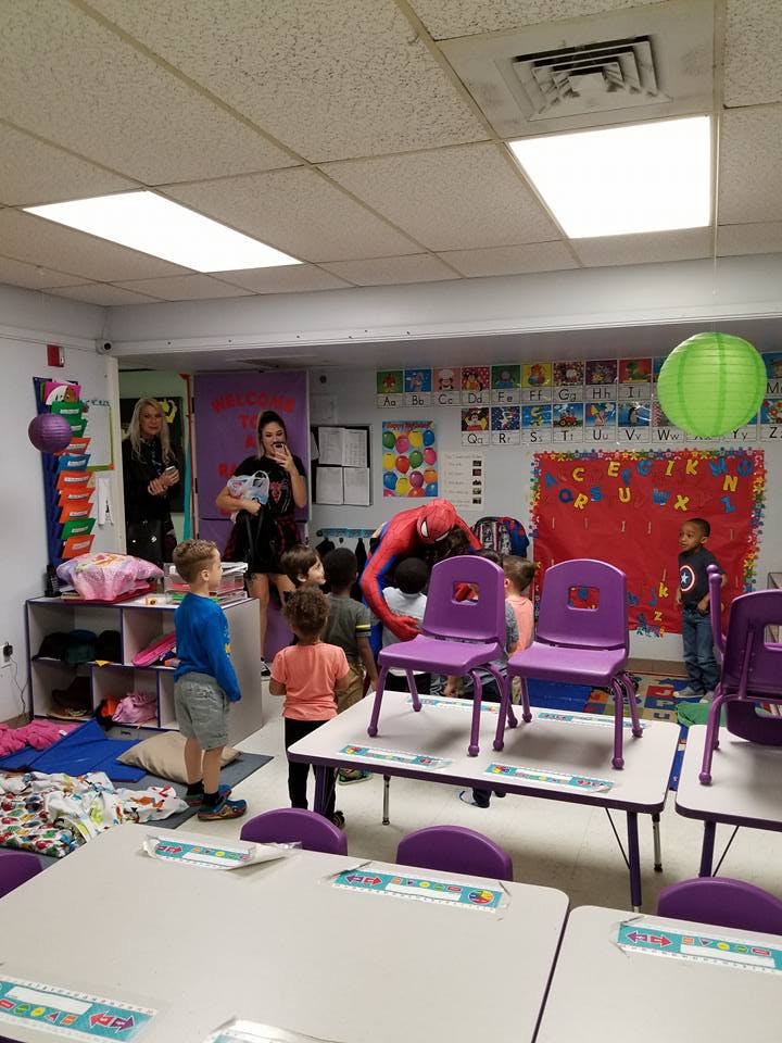 People and children in a classroom