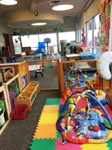 Playroom with colorful mats and various toys