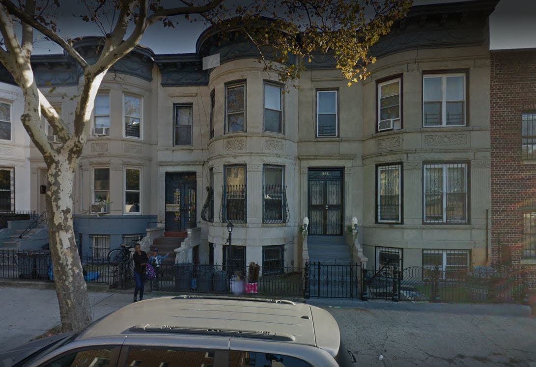 Row of residential buildings with bay windows and front stoops