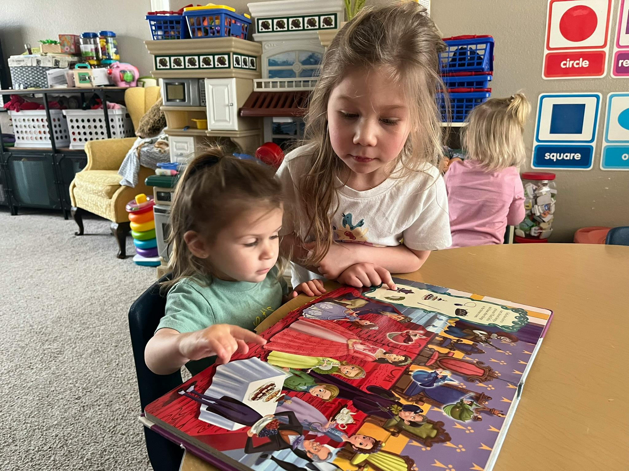 Two children looking at a book together
