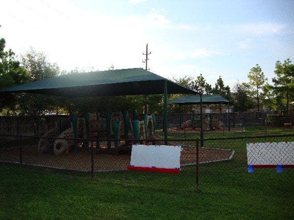 Playground with shade structure and fence