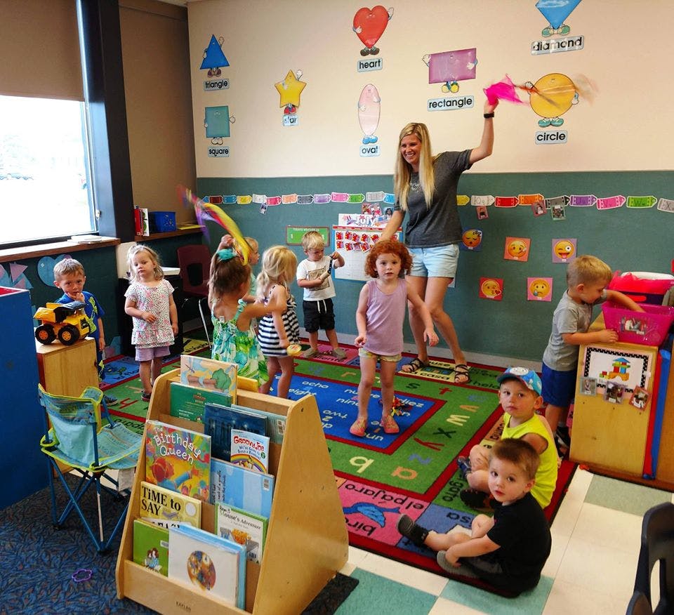 Adult and children playing in a classroom