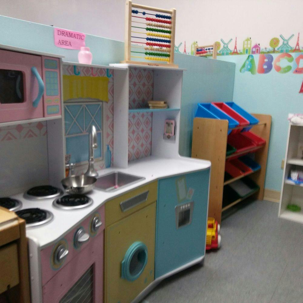 Play kitchen with stove, sink, and microwave in a classroom