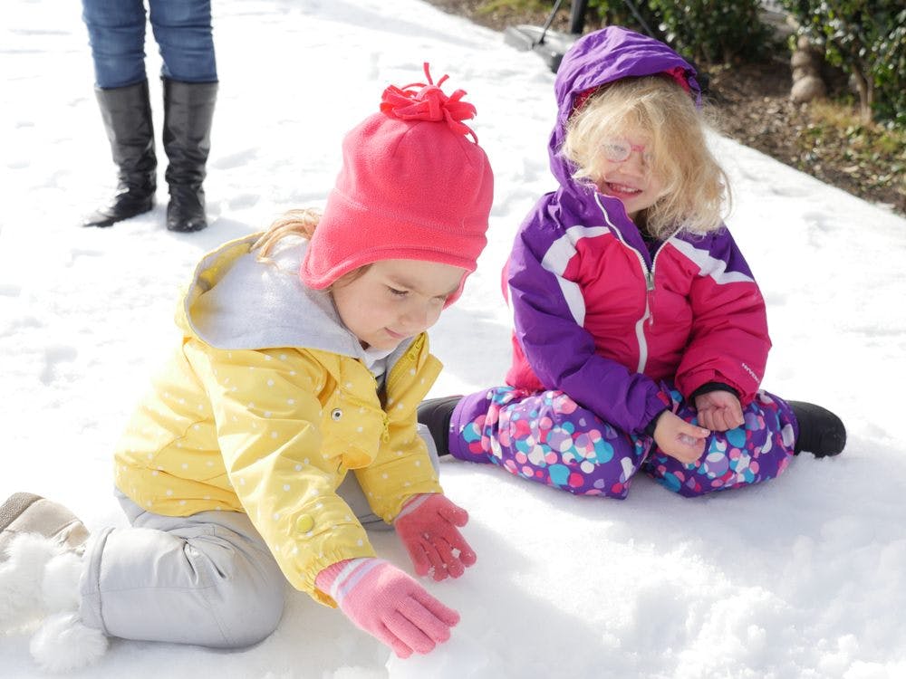 Two children playing in the snow