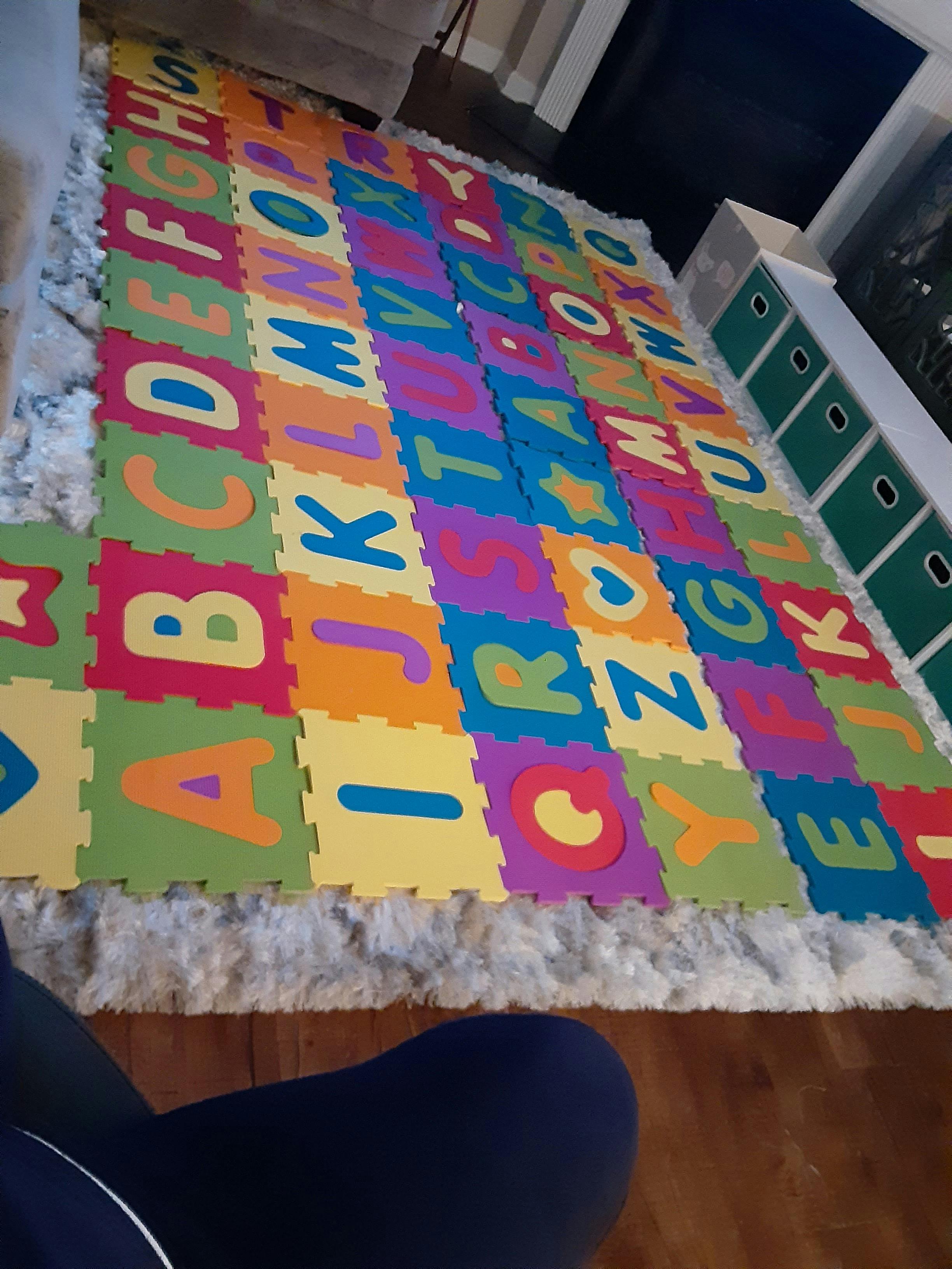 Colorful alphabet play mat on a rug