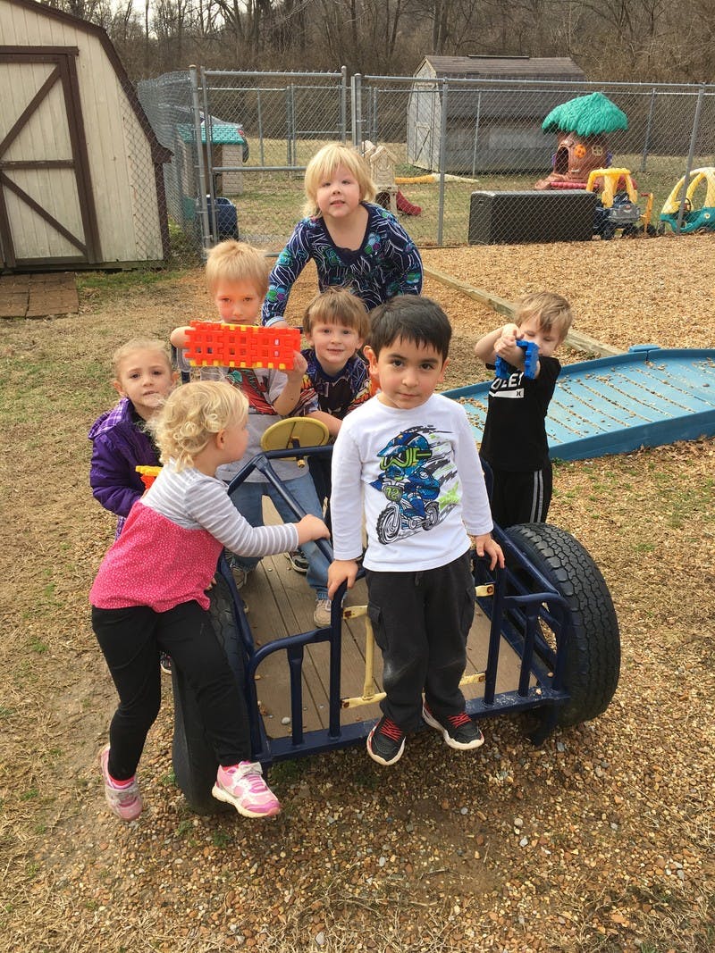 Group of children playing on outdoor playground equipment