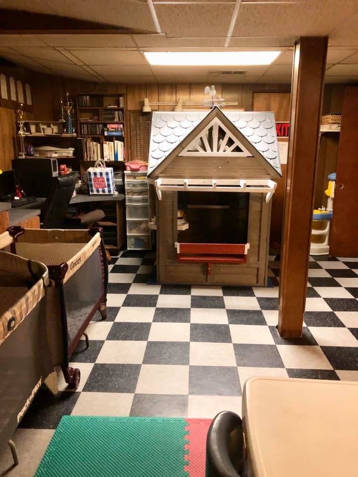 Playhouse and cribs in a room with checkered floor
