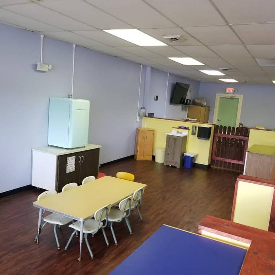 Empty classroom with small tables and chairs