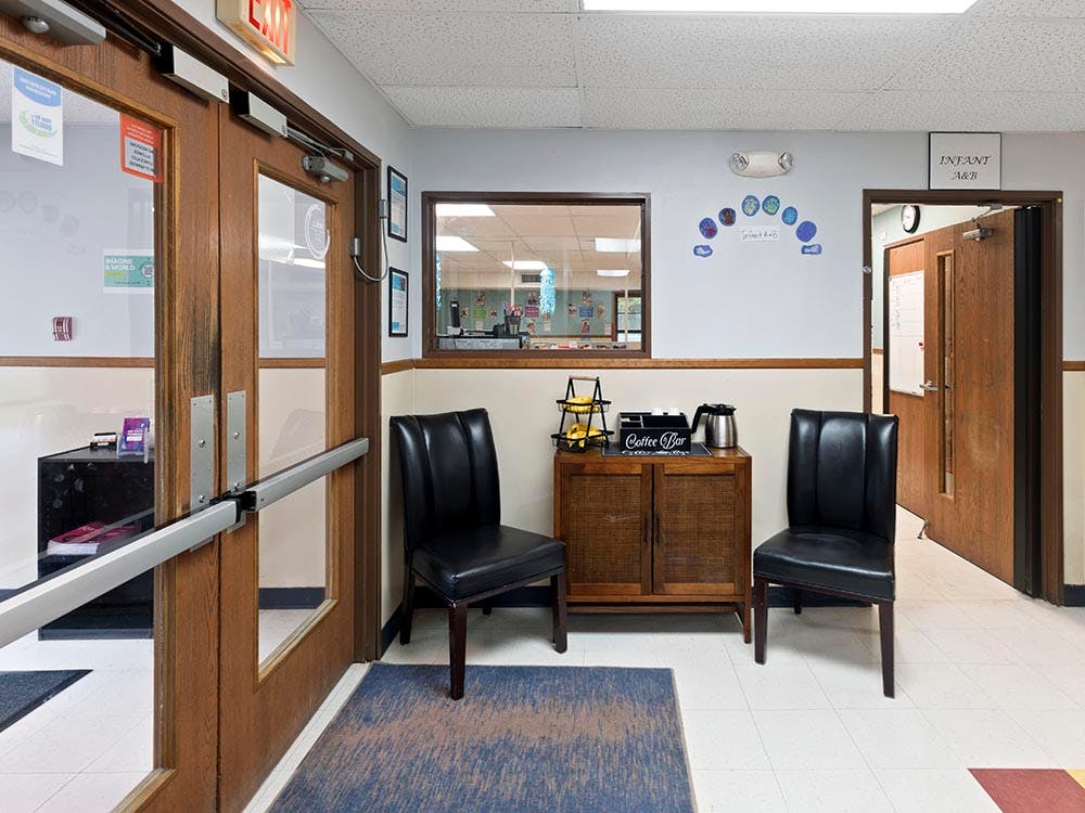 Lobby with a coffee bar, seating, and wooden doors