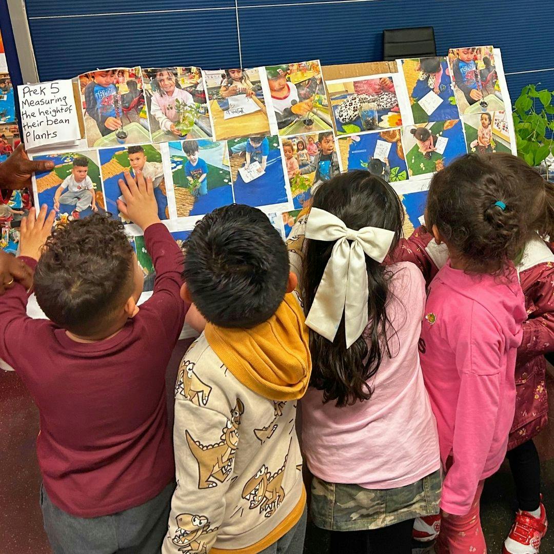 Children looking at photos on a table