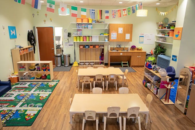 Empty colorful classroom with small tables and chairs