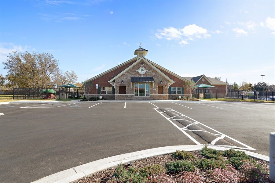 Building with a large parking lot in front