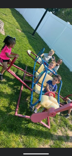 Children playing on a playground ride