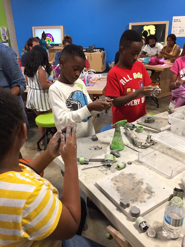 Children working with clay at a table