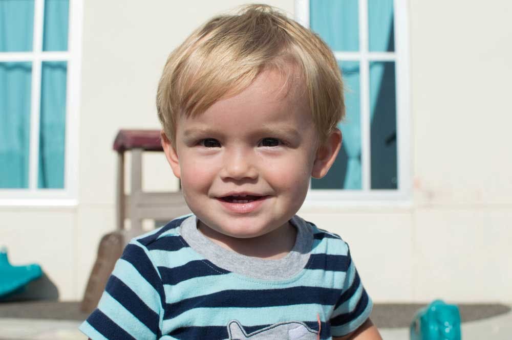 Child in a striped shirt smiling
