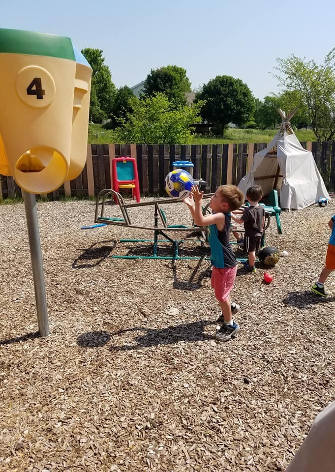 Child playing with a ball on a playground