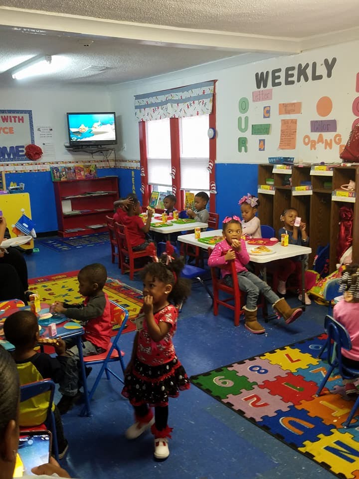 Children sitting at tables in a classroom