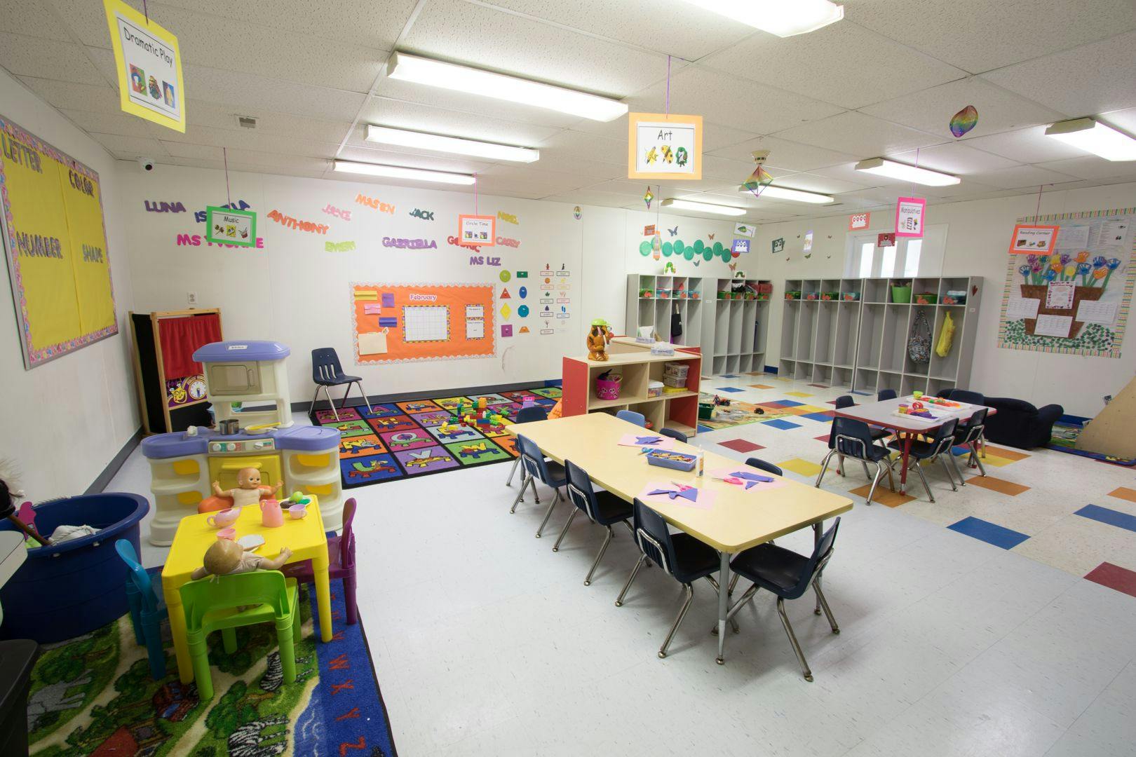 Empty classroom with tables, chairs, and colorful decorations