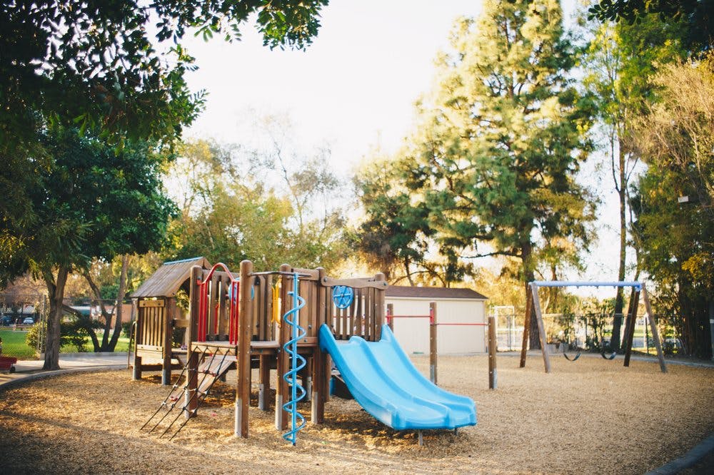 Playground with blue slide and swings