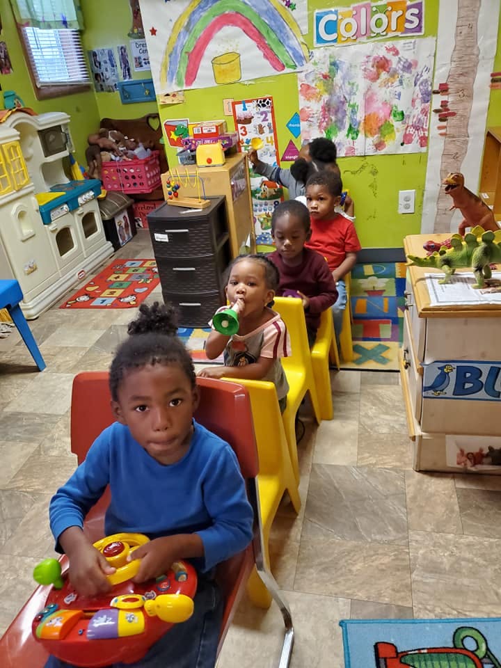 Children sitting in chairs in a classroom