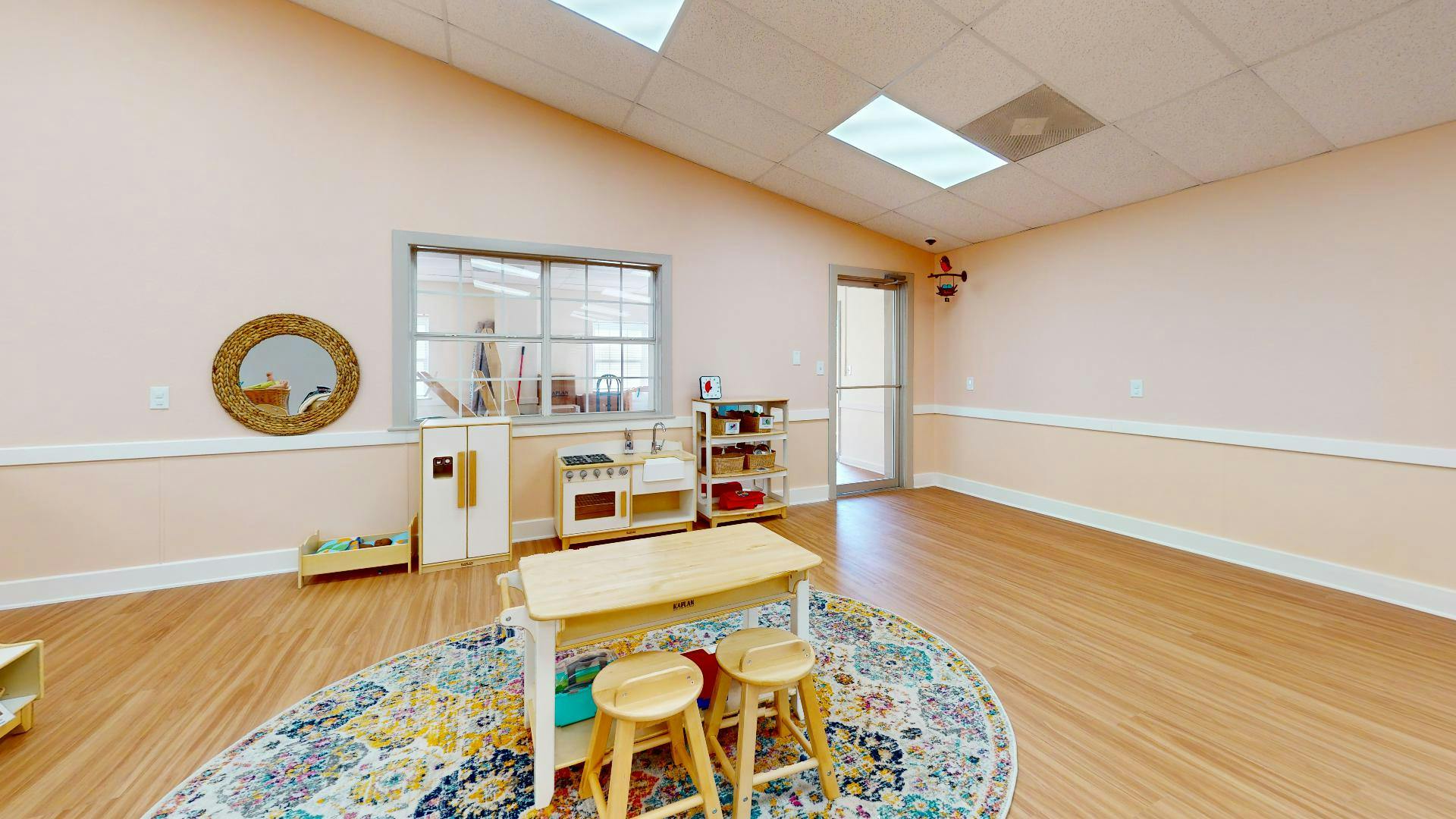 Classroom with small table and stools on a rug