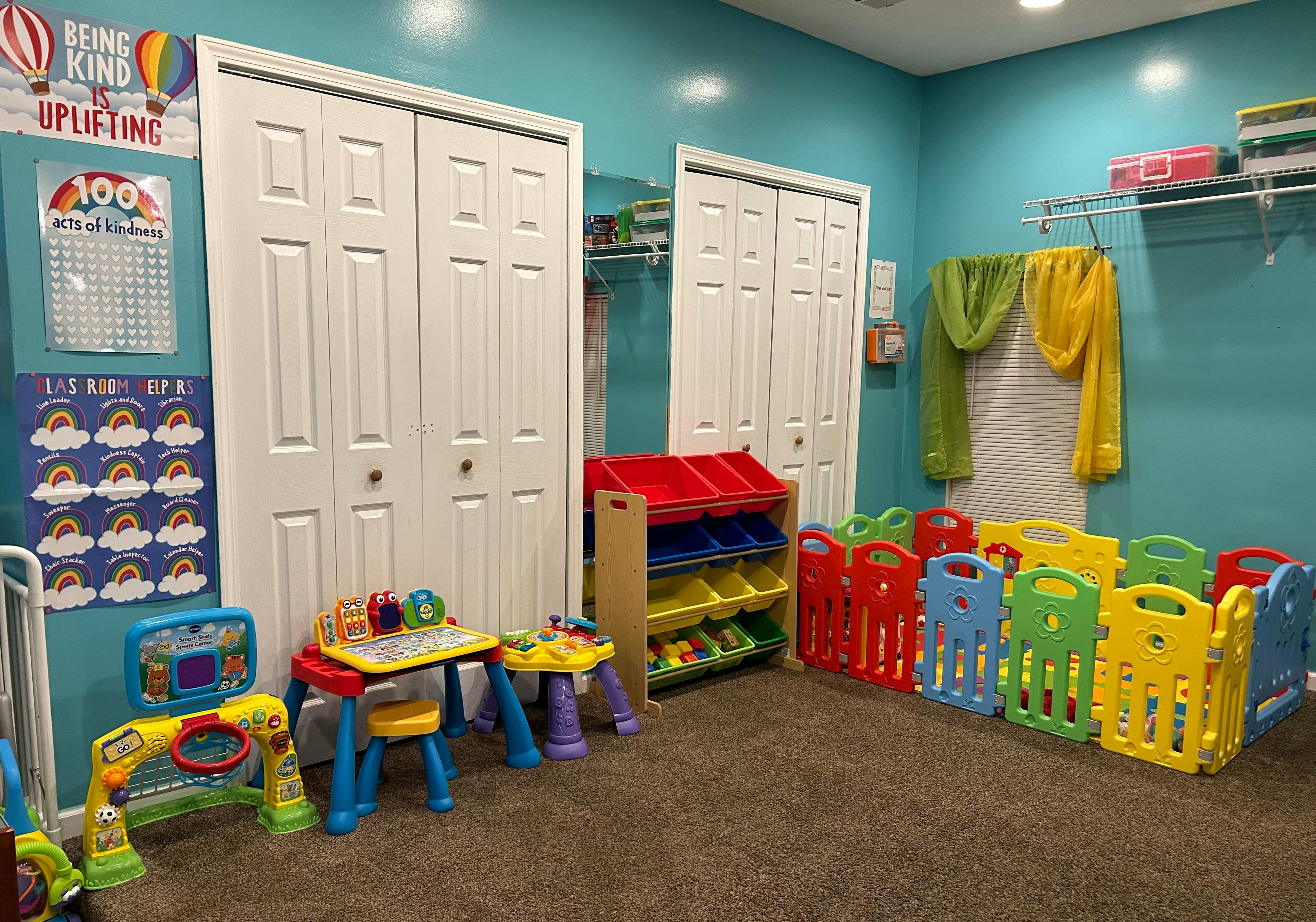Playroom with colorful toys, storage bins, and child-sized furniture