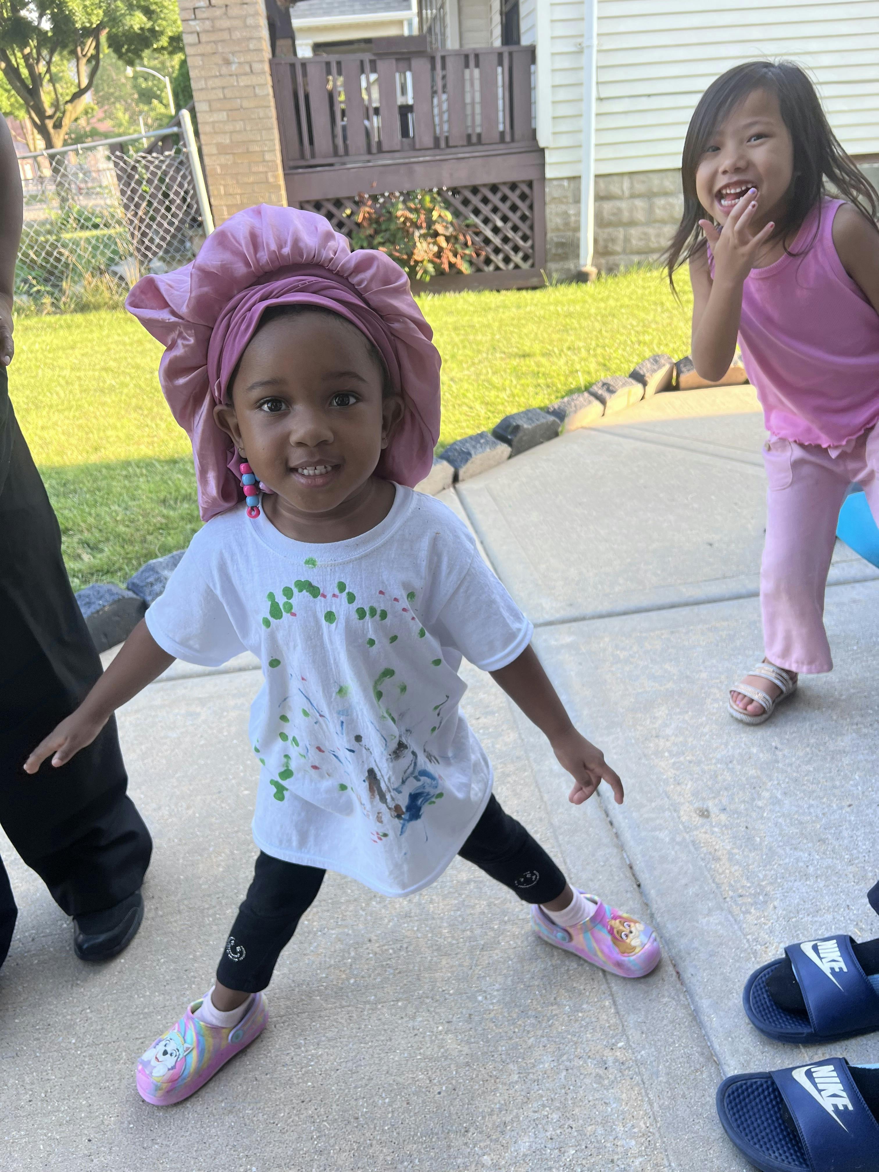 Child in pink bonnet and another child