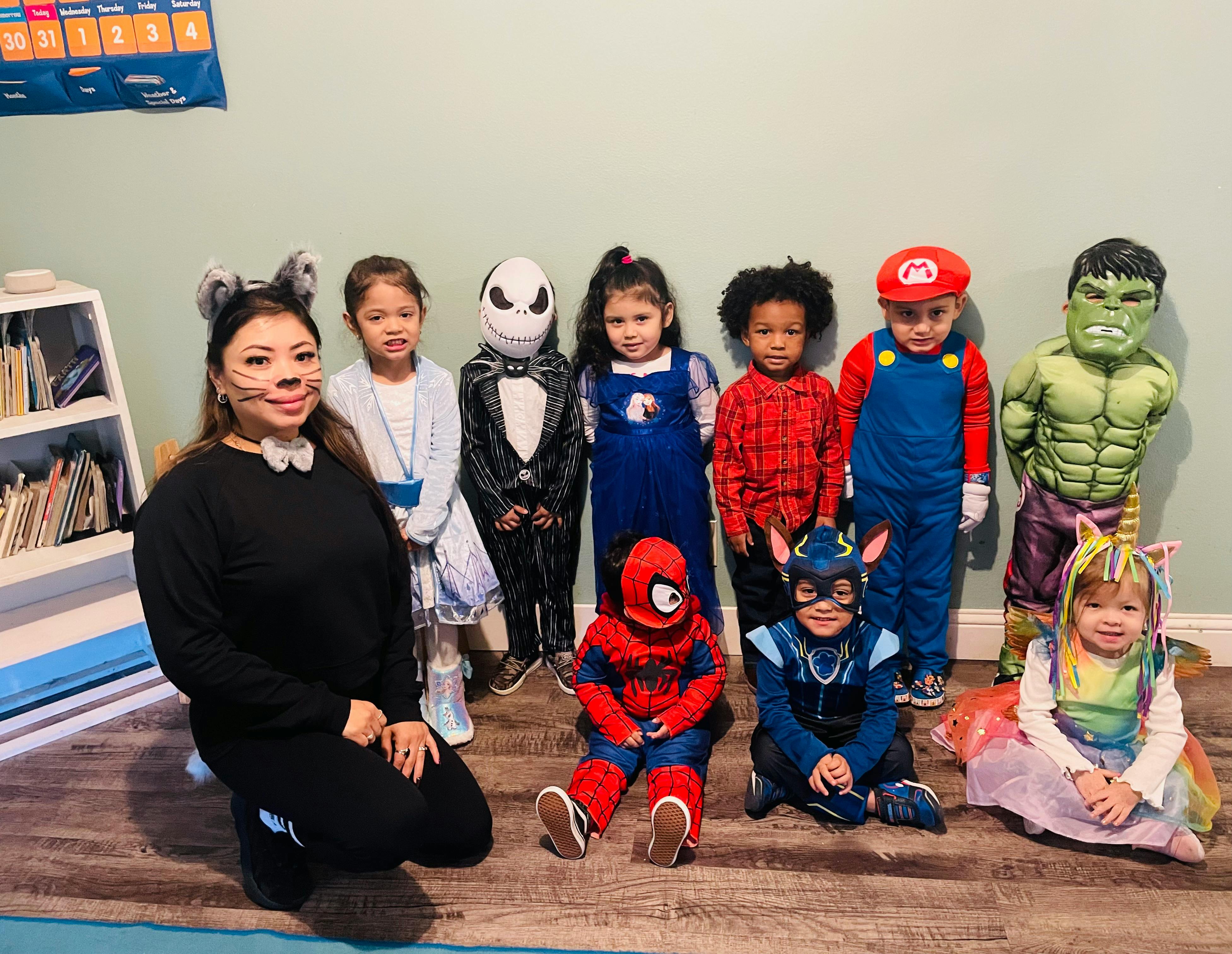 Adult and children in various costumes posing together