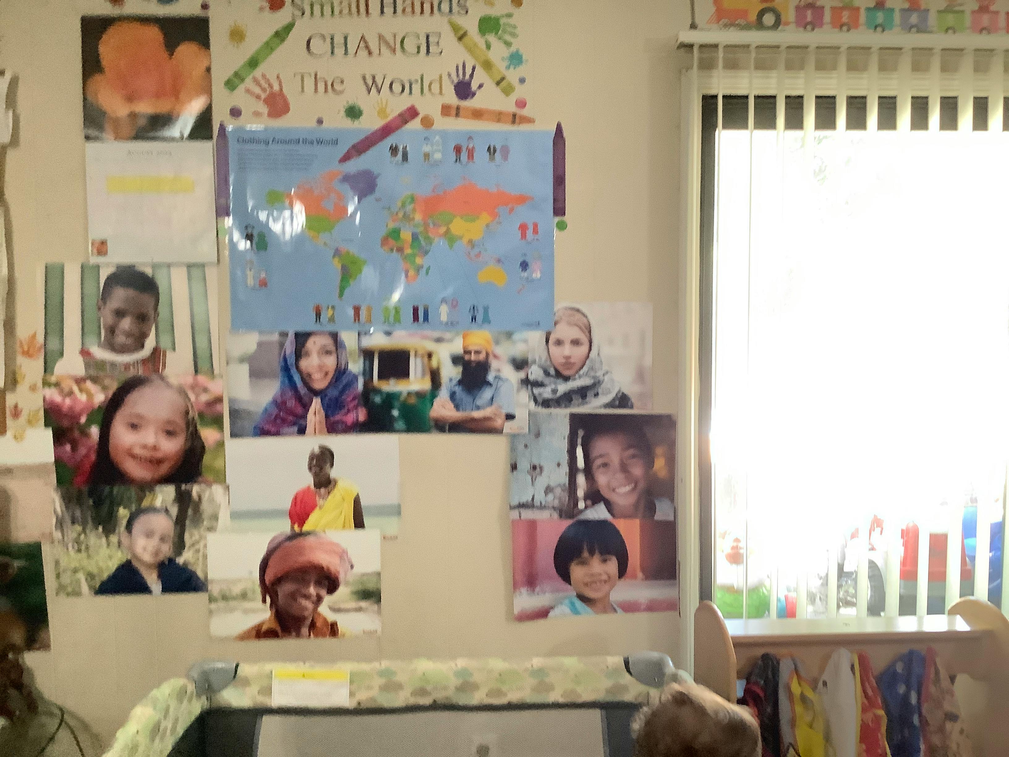 Wall display with world map and photos of children from different countries