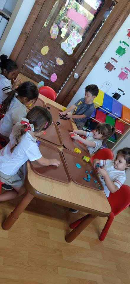 Children playing with modeling clay at a table