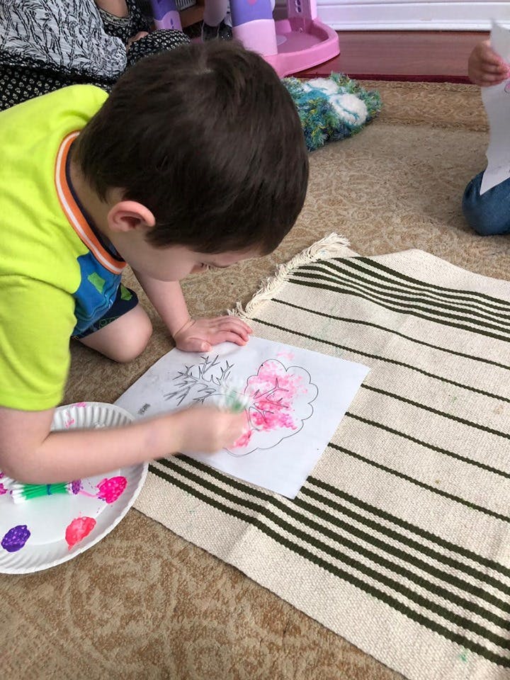 Child painting a picture on the floor