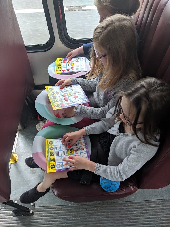 Children playing bingo on a bus