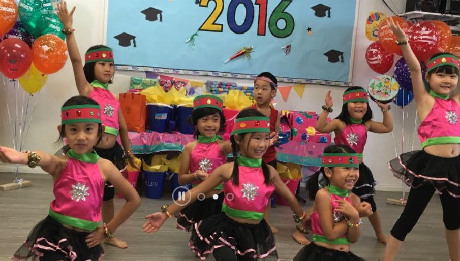 Children in matching outfits dancing
